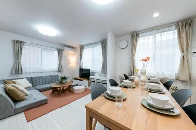 a dining room and living room with a table and a couch at HOTEL Peerson - Vacation STAY 73421v in Tokyo