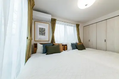 a bedroom with a large white bed and a window at HOTEL Peerson - Vacation STAY 73421v in Tokyo