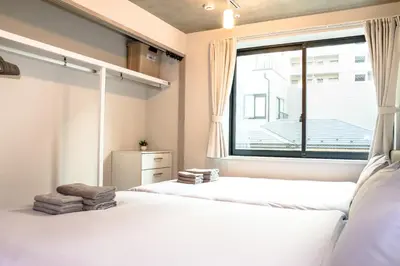 a bedroom with two beds and a large window at Seirai Asakusa Vacation Rental - Vacation STAY 81010v in Tokyo