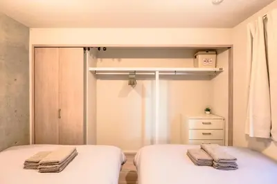 two beds in a small room with towels on them at Seirai Asakusa Vacation Rental - Vacation STAY 81010v in Tokyo