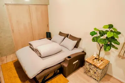 a bed with pillows and a potted plant on it at Seirai Asakusa Vacation Rental - Vacation STAY 81015v in Tokyo