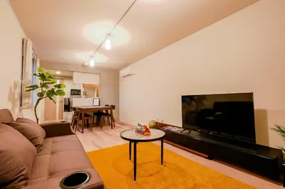 a living room with a couch and a large flat screen tv at Seirai Asakusa Vacation Rental - Vacation STAY 81015v in Tokyo