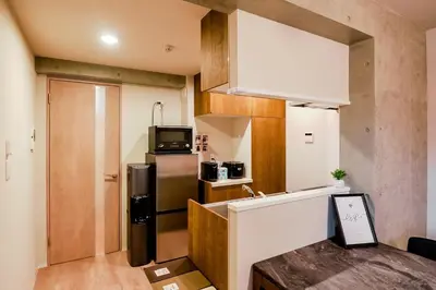 a small kitchen with a refrigerator and a microwave at Seirai Asakusa Vacation Rental - Vacation STAY 80997v in Tokyo