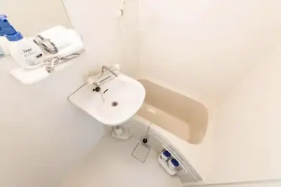 a white bathroom with a sink and a toilet at Masaya setagaya in Tokyo