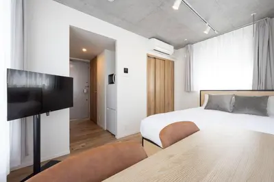 a bedroom with a bed and a table and chairs at Lega land\u5e61\u30f6\u8c37ANNEX in Tokyo