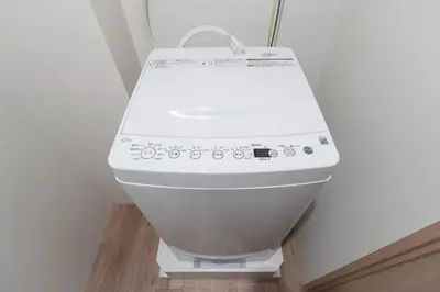 a white toilet in a corner of a room at Lega land\u5e61\u30f6\u8c37ANNEX in Tokyo
