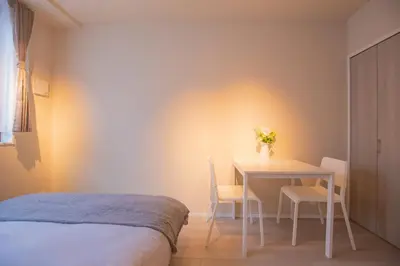 a bedroom with a bed and a table and chairs at The most comfortable and best choice for accommodation in Yoyogi EoE5 in Tokyo