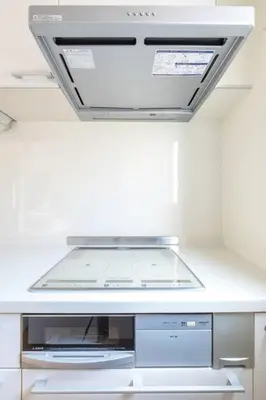 a white kitchen with a stove top oven at SKY GATE Azabu in Tokyo