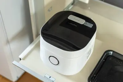 a white and black appliance on a counter with a phone at SKY GATE Azabu in Tokyo