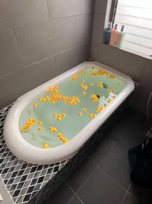 a bath tub with flowers in it in a bathroom at \u6d17\u8db321 in Tokyo