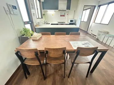 a kitchen with a wooden table and chairs at \u6d17\u8db321 in Tokyo