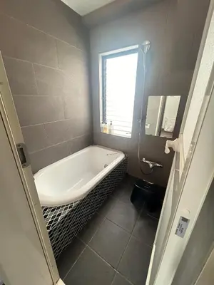a bathroom with a bath tub and a window at \u6d17\u8db321 in Tokyo
