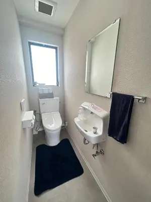 a bathroom with a toilet and a sink and a mirror at \u6d17\u8db321 in Tokyo