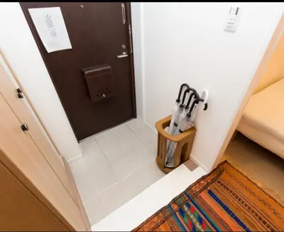 a room with a door and a wooden container with utensils at Ikebukuro 702 in Tokyo