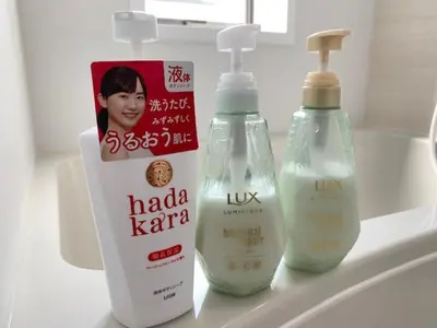 two bottles of hand soap and a pamphlet on a sink at Ikebukuro 702 in Tokyo