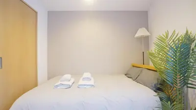 a bedroom with a white bed with towels on it at TOKYO AKATSUKI HOTEL in Tokyo
