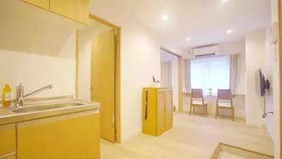 a kitchen with a sink and a kitchen with a table at TOKYO AKATSUKI HOTEL in Tokyo