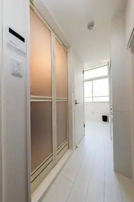 an empty corridor with a glass door in a room at Nano Kamiochiai by Tranova in Tokyo