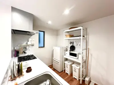a kitchen with a stove and a white refrigerator at Otsuka House-TS0006 in Tokyo