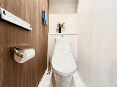 a white toilet in a bathroom with a toilet paper dispenser at Otsuka House-TS0006 in Tokyo