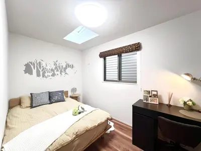 a bedroom with a bed and a desk and a window at Otsuka House-TS0006 in Tokyo