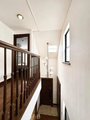 a staircase in a home with white walls and wooden railings at Hanegi House -SE0417 in Tokyo