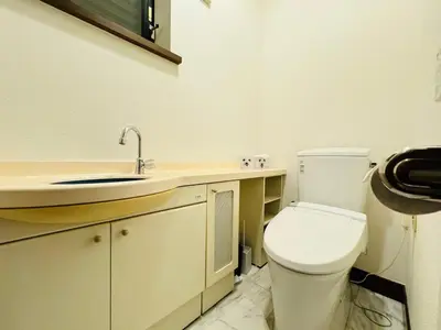 a bathroom with a white toilet and a sink at Hanegi House -SE0417 in Tokyo