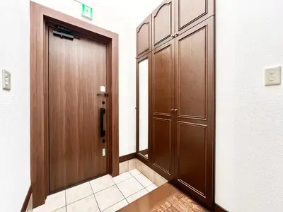 a corridor with two wooden doors in a building at Hanegi House -SE0417 in Tokyo