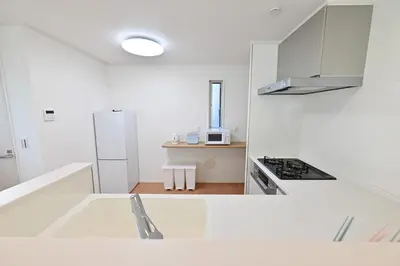 a kitchen with white cabinets and a white refrigerator at 小春日和-東新宿獨立包棟/車站3分鐘＿玥澄館 in Tokyo