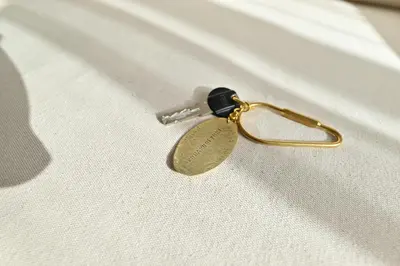 a gold key on top of a white shirt at 小春日和-東新宿獨立包棟/車站3分鐘＿玥澄館 in Tokyo