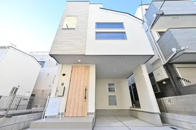 a white house with a wooden door at 小春日和-東新宿獨立包棟/車站3分鐘＿玥澄館 in Tokyo