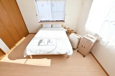 a small room with two beds and a window at Private Villa Sinjuku -7min to \u9ad8\u7530\u99ac\u5834\u99c5 in Tokyo
