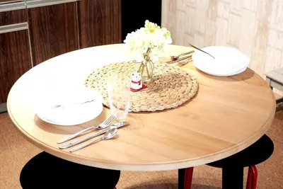 a round wooden table with a vase of flowers on it at \u30a2\u30f3\u30c9\u30b9\u30c6\u30a4\u5e61\u30f6\u8c37202 in Tokyo