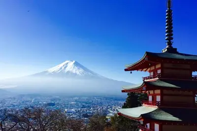 a pagoda with a mountain in the background at \u30a2\u30f3\u30c9\u30b9\u30c6\u30a4\u5e61\u30f6\u8c37202 in Tokyo