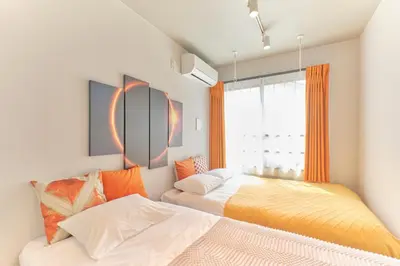 a bedroom with two beds and a window at Blighton Miyoshi by Tranova in Tokyo