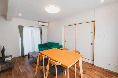 a living room with a wooden table and chairs at LT Shinjuku West in Tokyo