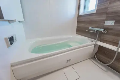 a bath tub with a hose in a bathroom at LT Shinjuku West in Tokyo
