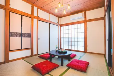 a room with a table and red cushioned chairs at New! Kamata close Haneda AP - Traditional & Hot Spring in Tokyo