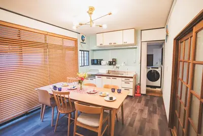 a kitchen with a table and chairs in a room at New! Kamata close Haneda AP - Traditional & Hot Spring in Tokyo