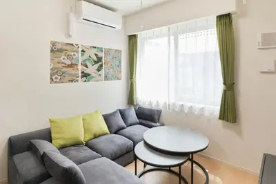 a living room with a couch and a table at J-ARC Akebonobashi by Tranova in Tokyo