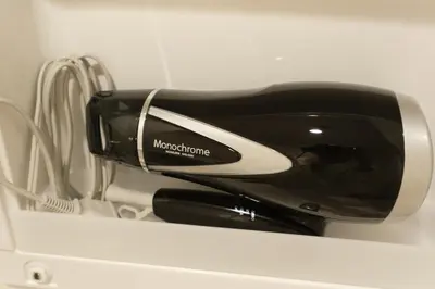 a hair dryer sitting on top of a shelf at J-ARC Akebonobashi by Tranova in Tokyo