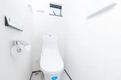 a bathroom with a toilet in a white room at Family Inn Hikifune in Tokyo