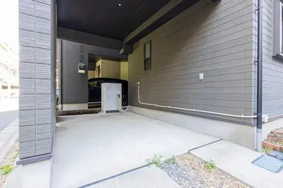 a garage door on a house with a refrigerator at Family Inn Hikifune in Tokyo
