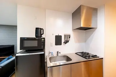 a small kitchen with a sink and a microwave at \u30c6\u30e9\u30b9\u5e73\u4e95 in Tokyo