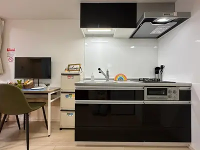 a kitchen with a stove and a sink at nestay inn tokyo ueno in Tokyo
