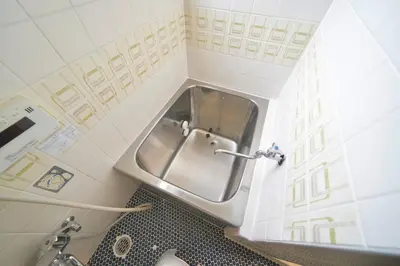 a bathroom with a stainless steel sink in the corner at TOMARIE Residential Suite Higashi-Tateishi in Tokyo