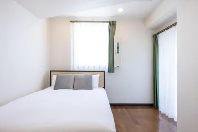 a bedroom with a bed and a large window at DeLCCS\u9ad8\u5186\u5bfa in Tokyo
