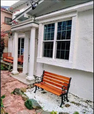 a wooden bench in front of a house at \u30b6\u30b9\u30bf\u30f3\u30c0\u30fc\u30c9\u30a2\u30d1\u30fc\u30c8\u30e1\u30f3\u30c8\u6e0b\u8c37\u7b39\u585aRoom A in Tokyo