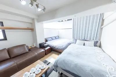 a living room with a couch and a bed at shinjuku, tokyo city hall, apartment, Hotel for Max 6 person in Tokyo