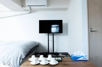 a bedroom with a bed with shoes on a table at shinjuku, tokyo city hall, apartment, Hotel for Max 6 person in Tokyo